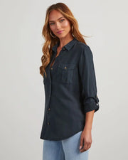 Model wearing long sleeve single breasted denim shirt