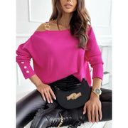 Model wearing trendy long-sleeve top with chain decoration